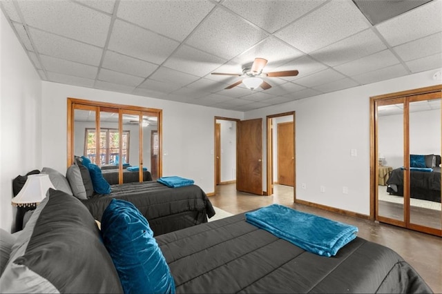 bedroom with a paneled ceiling, access to exterior, and baseboards