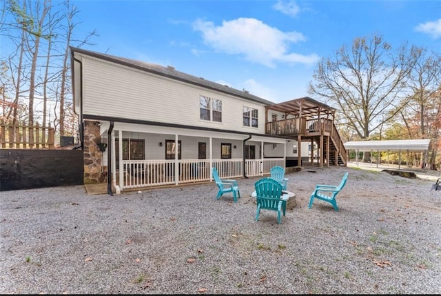 back of house with fence, stairway, and a wooden deck