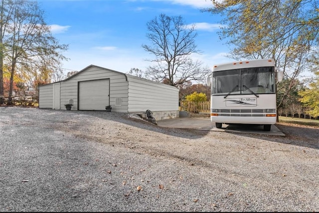 detached garage with gravel driveway