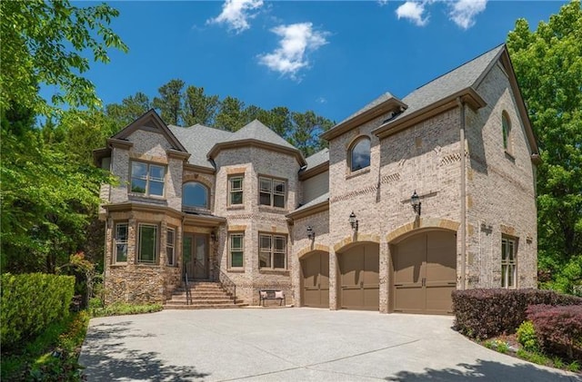 3680 Milton Park Dr, Alpharetta, GA 30022 - view of front of property with driveway, an attached garage, and brick siding