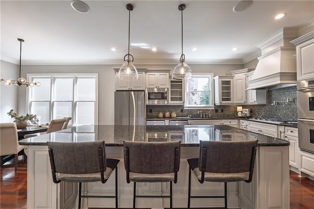 3680 Milton Park Dr, Alpharetta, GA 30022 - kitchen with appliances with stainless steel finishes, a sink, a kitchen island, tasteful backsplash, and dark wood-style floors