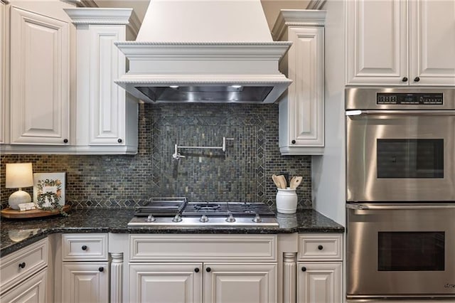 3680 Milton Park Dr, Alpharetta, GA 30022 - kitchen featuring stainless steel appliances, custom exhaust hood, backsplash, and white cabinets