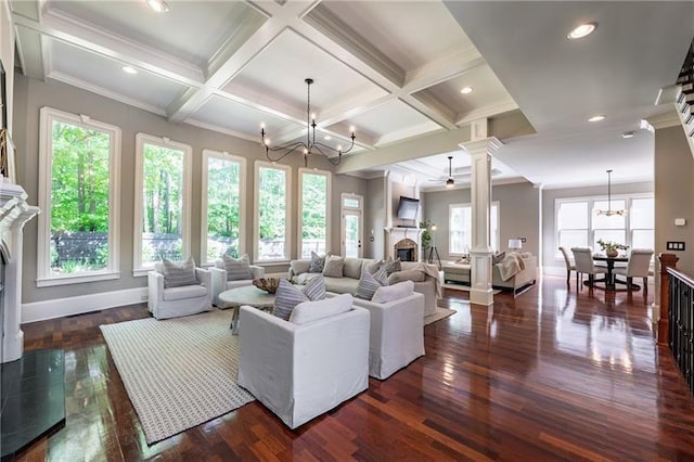 3680 Milton Park Dr, Alpharetta, GA 30022 - living room featuring a fireplace, ornate columns, a chandelier, dark wood-style flooring, and beam ceiling