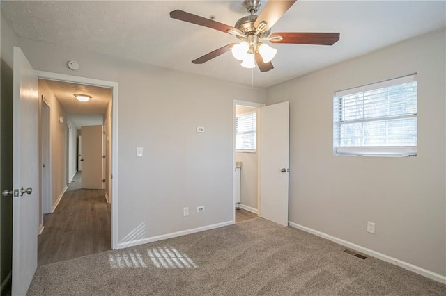 unfurnished bedroom with ceiling fan and carpet floors