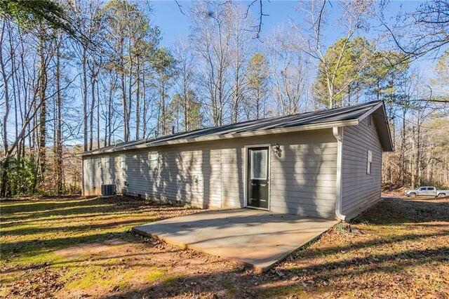 rear view of property featuring a lawn and a patio area