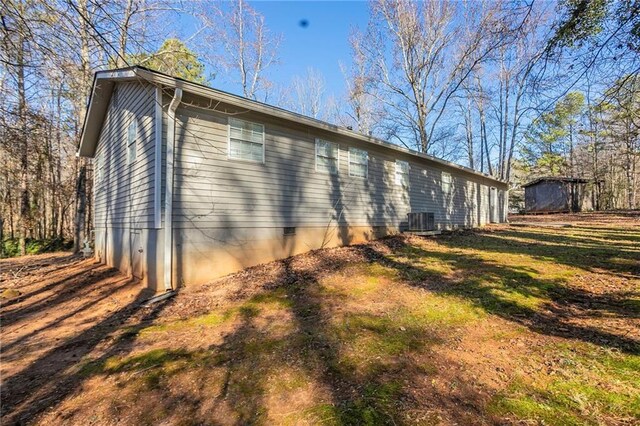 view of side of home with central AC unit