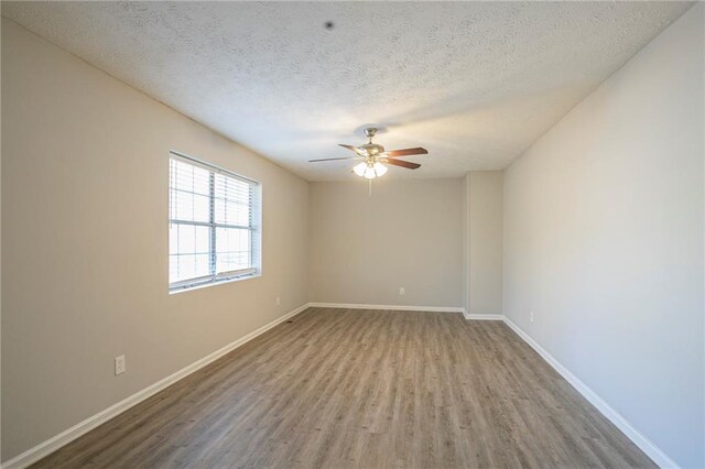 unfurnished room with hardwood / wood-style flooring, ceiling fan, and a textured ceiling