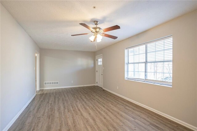 empty room featuring hardwood / wood-style floors and ceiling fan