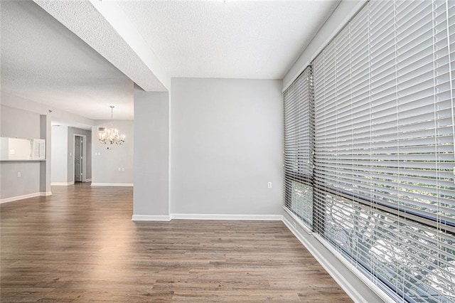 1800 Clairmont Lk Unit 412, Decatur, GA 30033 - spare room featuring a chandelier, a textured ceiling, wood finished floors, and baseboards