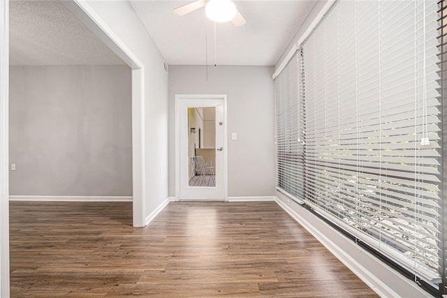 1800 Clairmont Lk Unit 412, Decatur, GA 30033 - empty room with wood finished floors, a ceiling fan, baseboards, and a textured ceiling