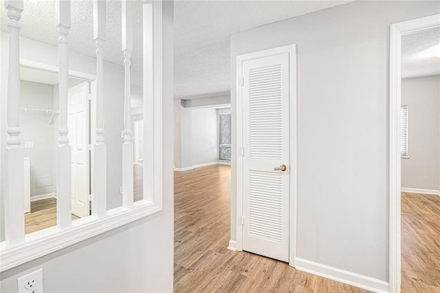 1800 Clairmont Lk Unit 412, Decatur, GA 30033 - hall featuring wood finished floors, a textured ceiling, and baseboards