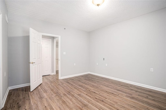 1800 Clairmont Lk Unit 412, Decatur, GA 30033 - spare room with wood finished floors, a textured ceiling, and baseboards
