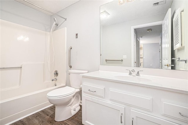 1800 Clairmont Lk Unit 412, Decatur, GA 30033 - bathroom featuring toilet, shower / washtub combination, a textured ceiling, vanity, and wood finished floors