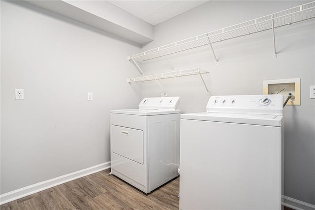1800 Clairmont Lk Unit 412, Decatur, GA 30033 - laundry room with independent washer and dryer, wood finished floors, and baseboards