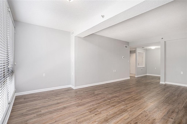 1800 Clairmont Lk Unit 412, Decatur, GA 30033 - spare room with wood finished floors, baseboards, and a textured ceiling