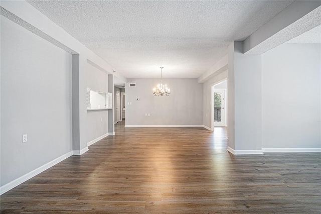 1800 Clairmont Lk Unit 412, Decatur, GA 30033 - spare room featuring a chandelier, a textured ceiling, dark wood-style flooring, and baseboards