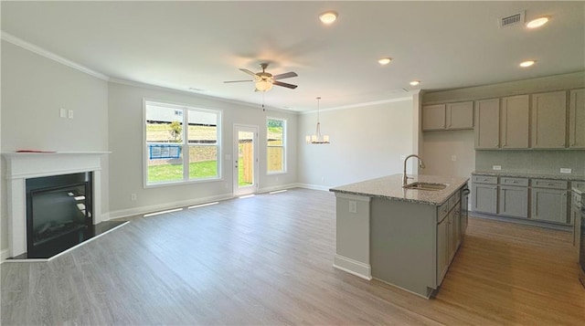 3817 Billabong Trl Unit 104, Gainesville, GA 30506 - kitchen featuring gray cabinetry, crown molding, a sink, and a fireplace with raised hearth