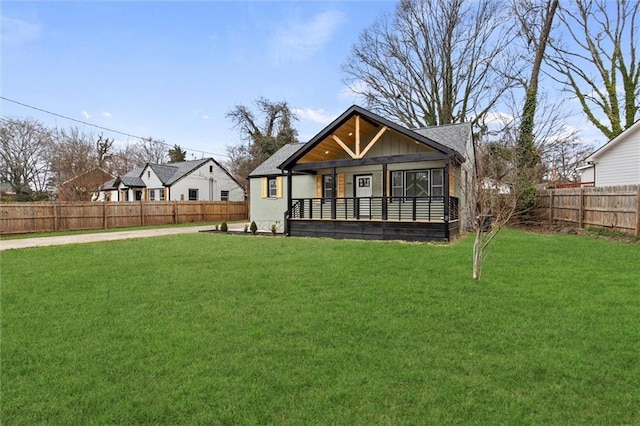 view of front of house featuring a fenced backyard and a front yard