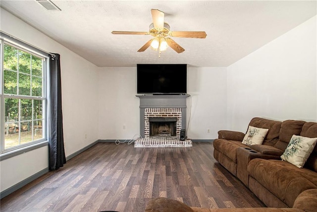 7341 Raleigh Way, Bethlehem, GA 30620 - living area featuring wood finished floors, a ceiling fan, baseboards, a brick fireplace, and a textured ceiling