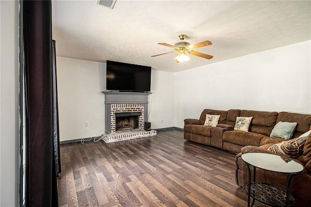 7341 Raleigh Way, Bethlehem, GA 30620 - living area featuring ceiling fan, dark wood-type flooring, a fireplace, a textured ceiling, and baseboards