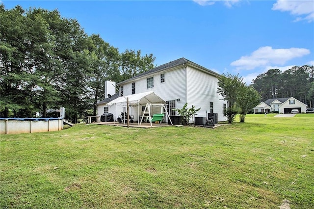 7341 Raleigh Way, Bethlehem, GA 30620 - back of property with a yard, a covered pool, a patio area, and central AC