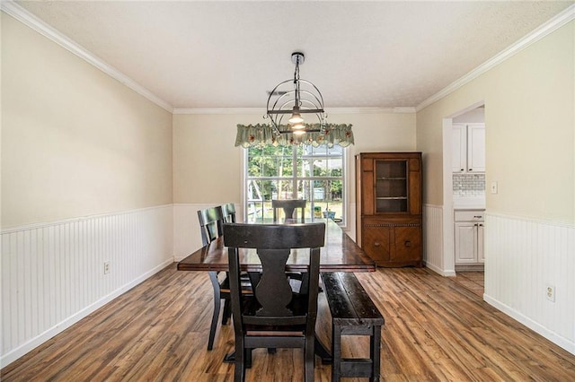 7341 Raleigh Way, Bethlehem, GA 30620 - dining area with wood finished floors, wainscoting, a chandelier, and crown molding