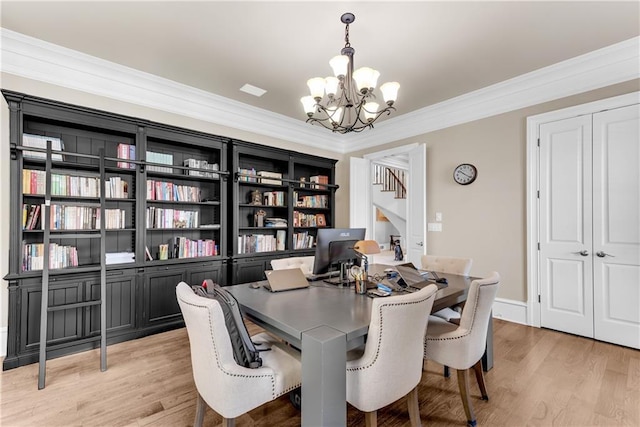 dining space with baseboards, light wood-style flooring, a chandelier, and crown molding