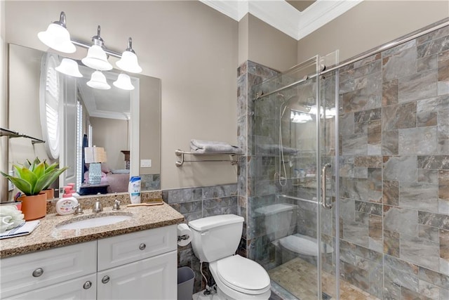 bathroom with ornamental molding, vanity, toilet, and a shower with door