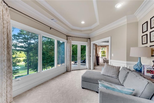 carpeted living room featuring french doors, ornamental molding, wainscoting, and visible vents