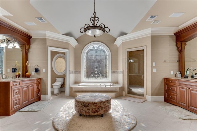 full bathroom with a stall shower, a garden tub, vaulted ceiling, and vanity