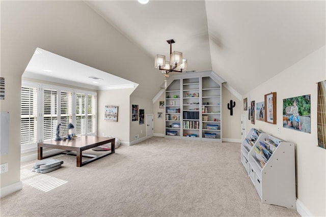 sitting room with carpet flooring, vaulted ceiling, a notable chandelier, and baseboards