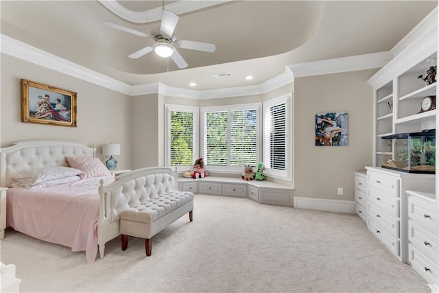 bedroom with a tray ceiling, visible vents, crown molding, and light colored carpet