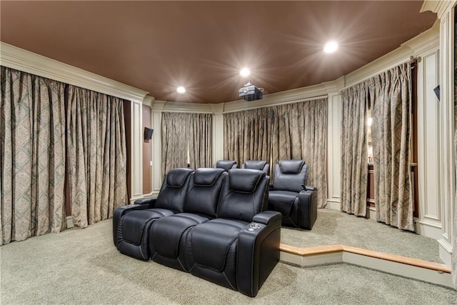 carpeted home theater room featuring recessed lighting and crown molding