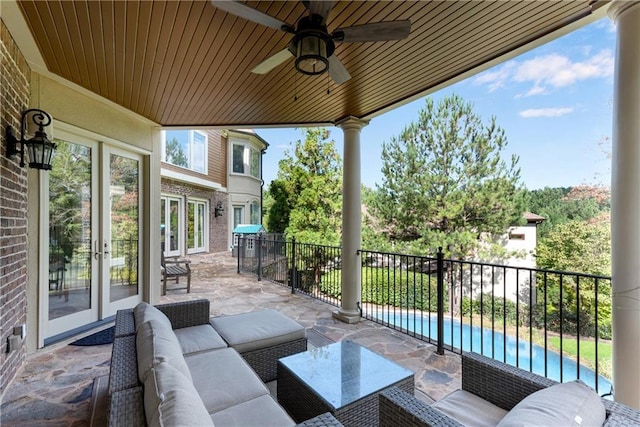 view of patio with a fenced in pool, an outdoor living space, a ceiling fan, and french doors