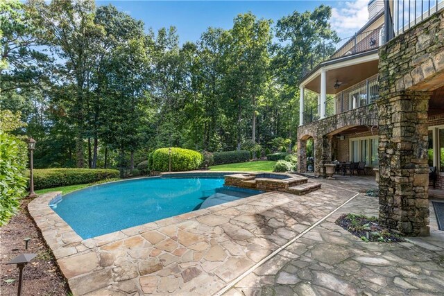 view of pool with a patio and an in ground hot tub