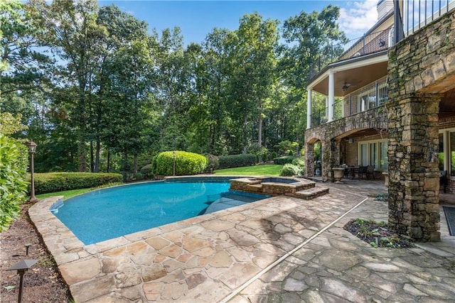 view of pool with a patio area, a pool with connected hot tub, and a ceiling fan