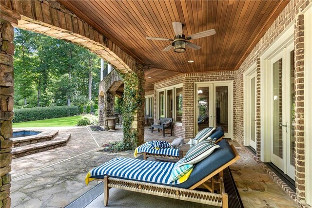 view of patio featuring ceiling fan and french doors