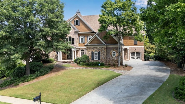 craftsman-style home featuring a front lawn and concrete driveway