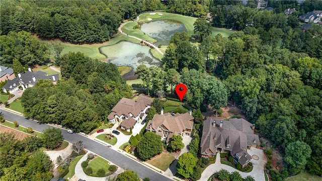 bird's eye view with view of golf course, a water view, a residential view, and a view of trees