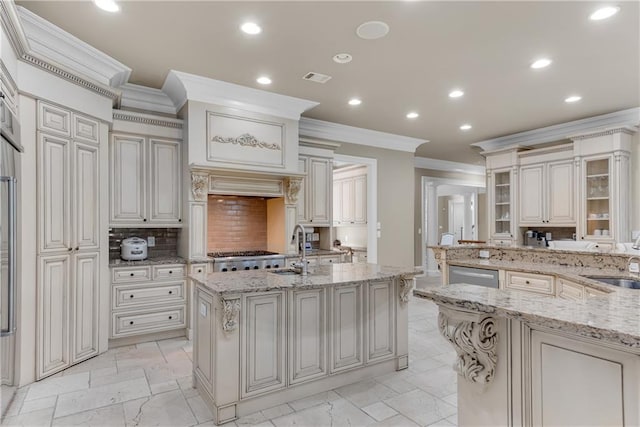 kitchen with visible vents, decorative backsplash, ornamental molding, a sink, and recessed lighting