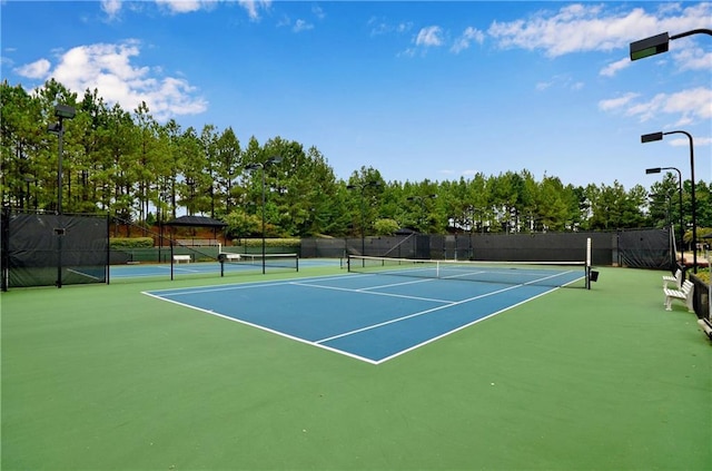 view of tennis court with fence