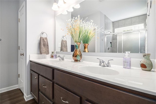 bathroom featuring vanity, a shower with door, and hardwood / wood-style flooring