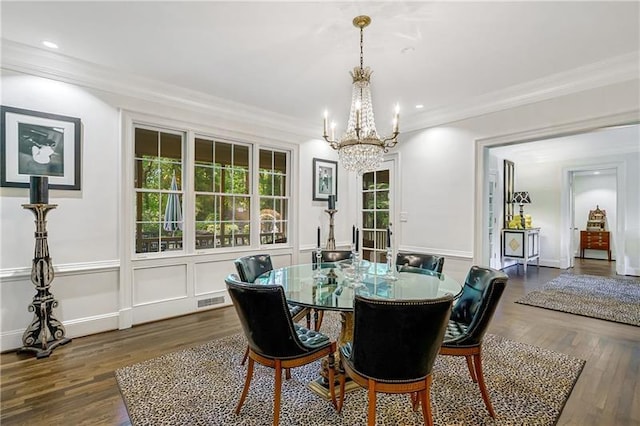dining area with a chandelier, dark wood-type flooring, ornamental molding, and recessed lighting