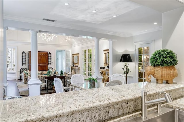 dining space with decorative columns, crown molding, plenty of natural light, and recessed lighting