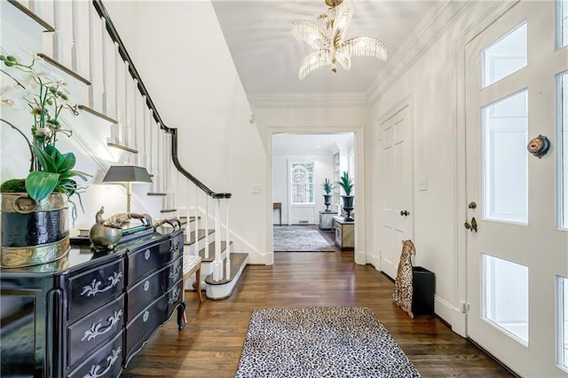 foyer entrance with stairway, a chandelier, dark wood-style flooring, and baseboards