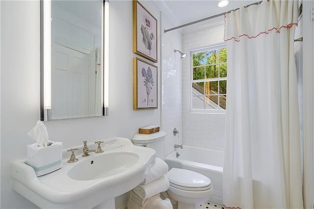 bathroom featuring toilet and shower / bath combination with curtain