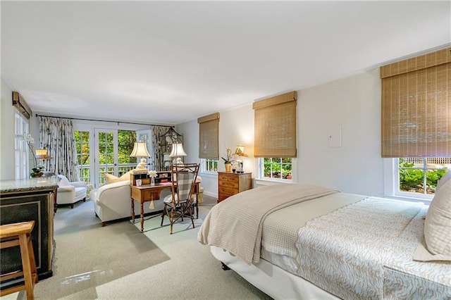 bedroom with multiple windows and carpet