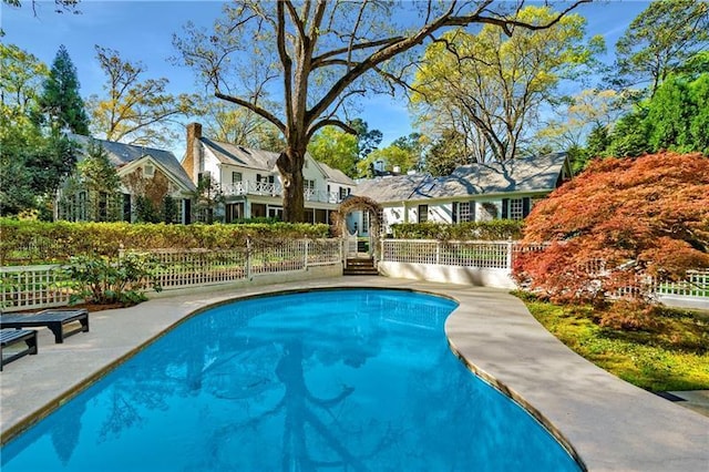 view of pool featuring fence and a patio area