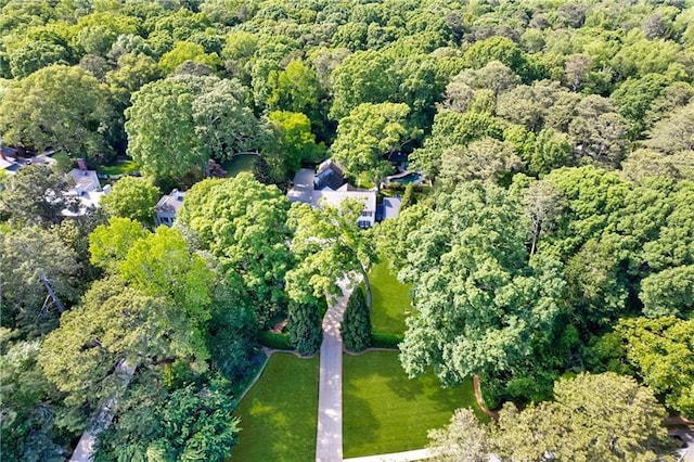 aerial view of property's location featuring a forest