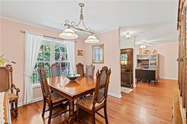 5584 Northwoods Rd, Clermont, GA 30527 - dining room featuring light wood finished floors, a ceiling fan, baseboards, and ornamental molding
